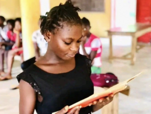 SGI SGI student reading a story about a female role model who has inspired her